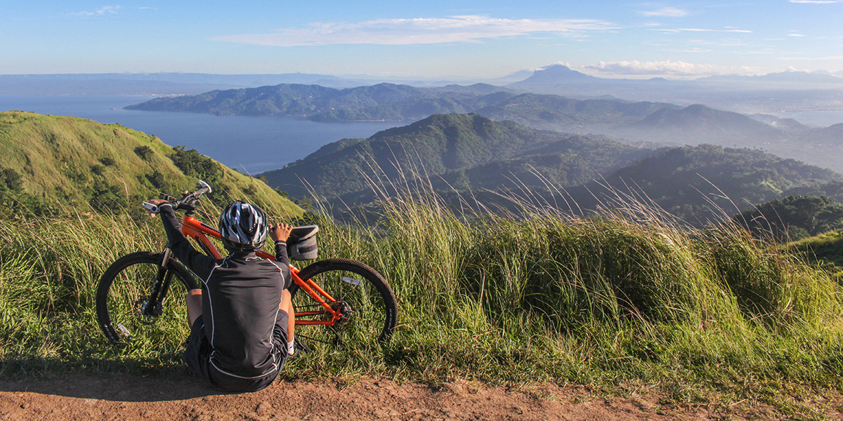 Mountain biker sitting with bike