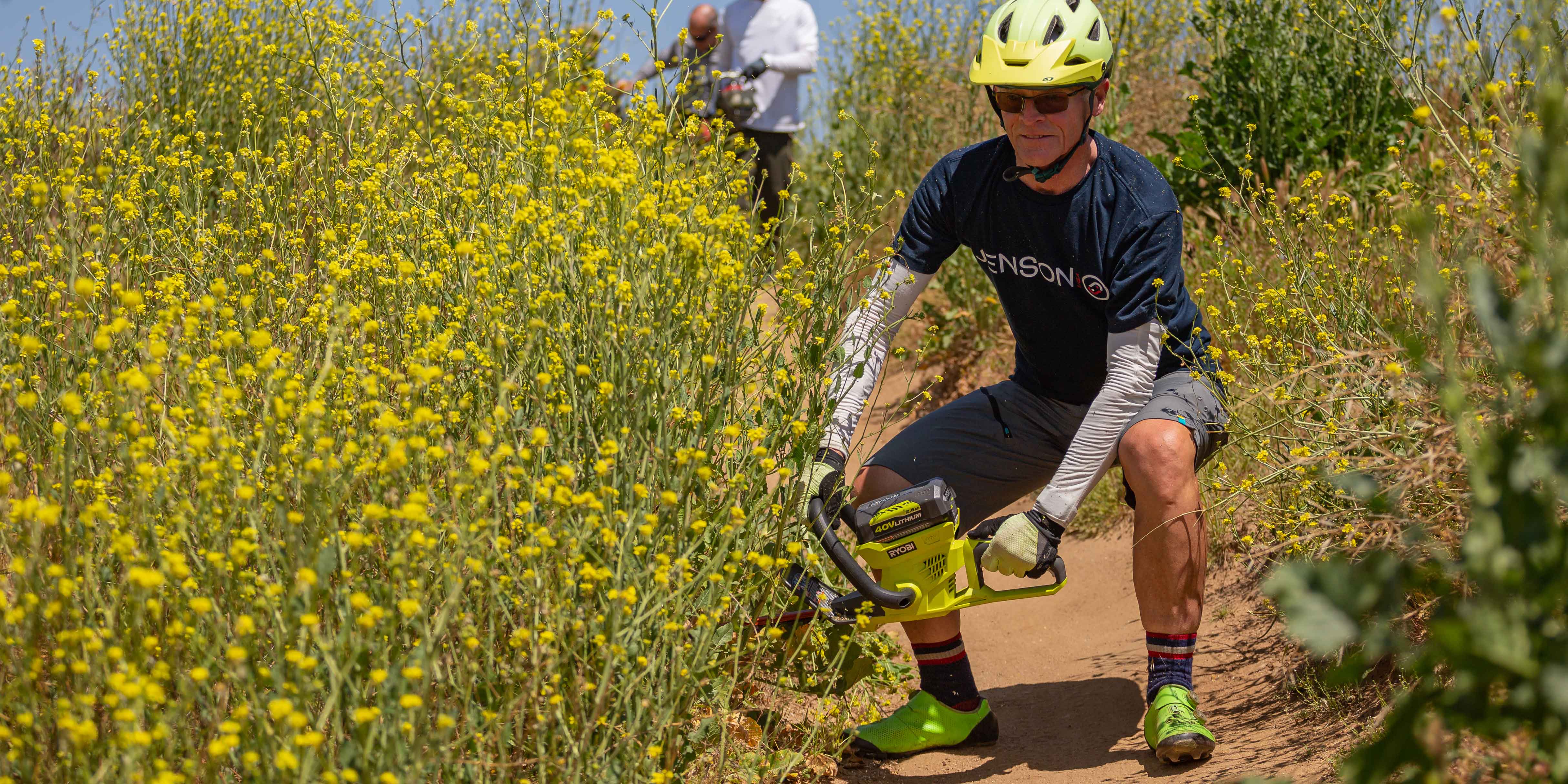 Jeff C. from bike build weed whacking the trails